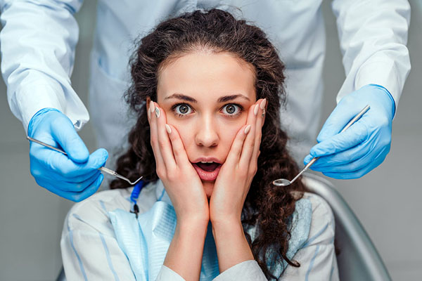 young woman feeling anxious about seeing the dentist